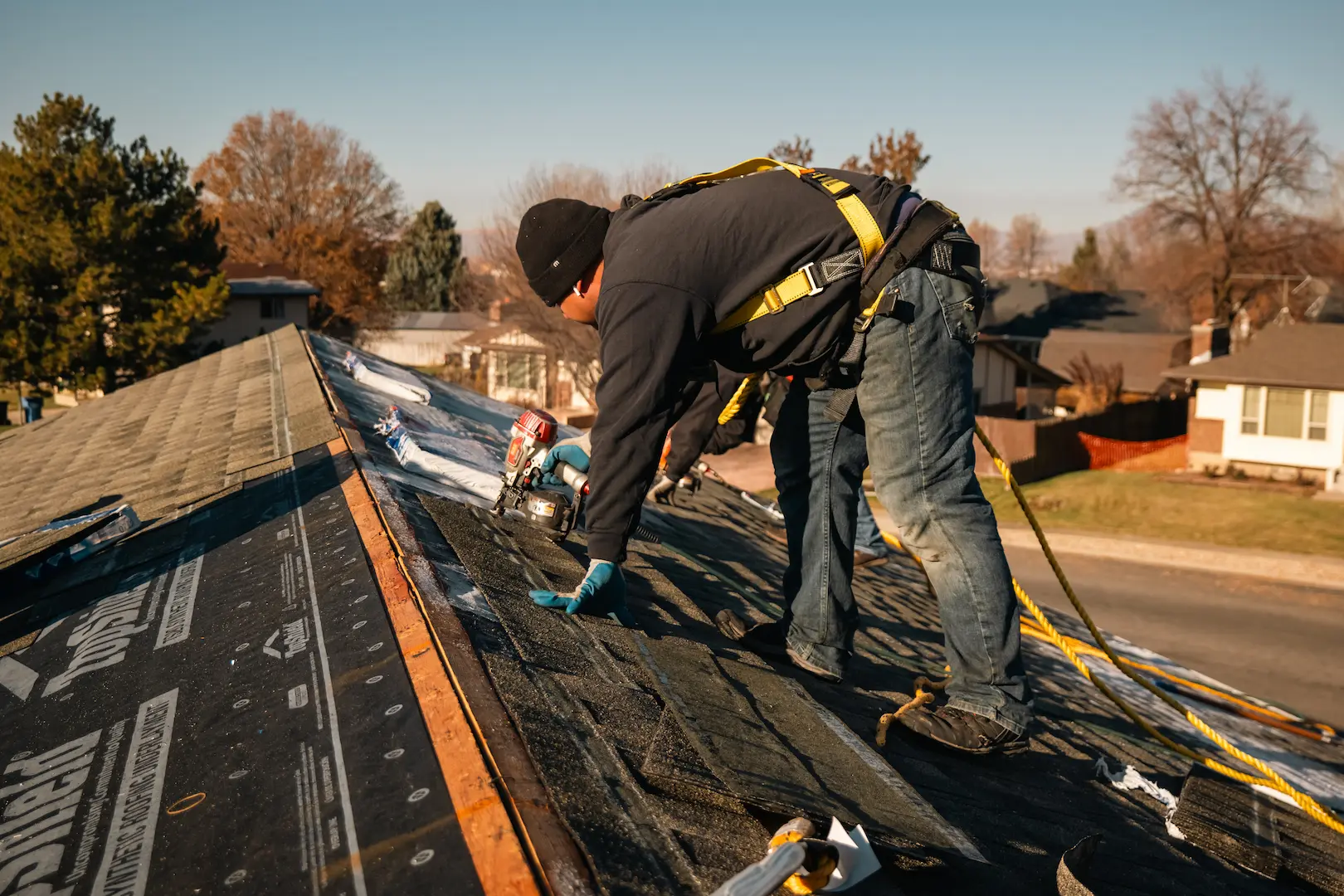 Homer Roofing crew nailing shingles on a Utah roof after storm damage
